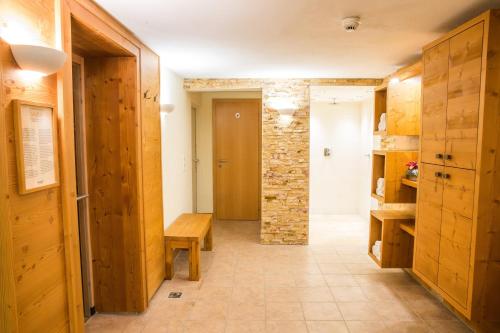 a hallway with a table and a stone wall at Ferienwohnungen Plattnerhof in Terfens