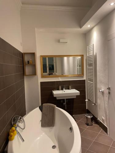a bathroom with a white tub and a sink at Chez Anna in Iesi
