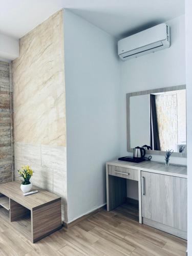 a bathroom with a sink and a mirror at Hotel Dabi Imperial in Donji Štoj