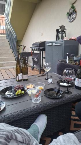 a table with food and wine glasses and wine bottles at 25m2 Studio with Kitchen in Zürich in Zurich