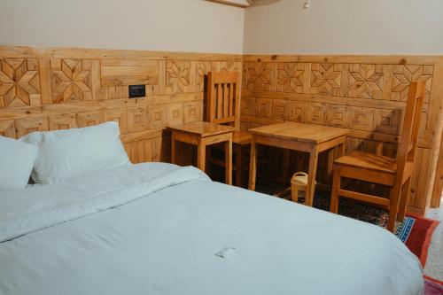 a bedroom with a bed and a table and chairs at Jigyasa Homestay in Almora