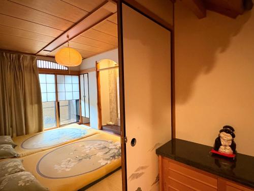a mirror in a room with a bed and a window at Just a short walk 心斎橋 Glico Sign 1min 道頓堀30-second 黒門市場 難波駅 Dotonbori Guesthouse 松の阁 in Osaka