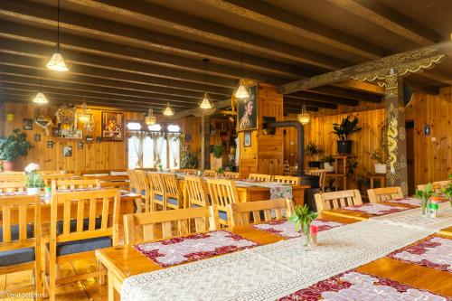a dining room with wooden tables and chairs at Phuntsho Guest House in Jakar