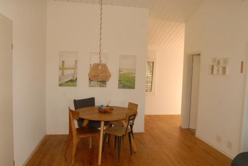 ein Esszimmer mit einem Holztisch und Stühlen in der Unterkunft Chalets Vacances in Avenches