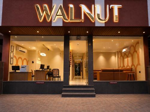 a walnut store with a sign on the front of it at Hotel Walnut - Near Jaipur Airport in Jaipur