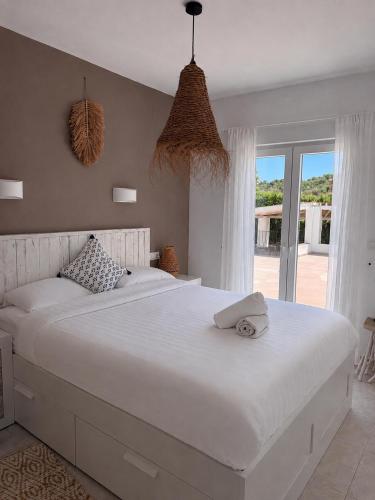 a bedroom with a large white bed with white sheets at Villa Sal y Mar - Jávea ! Freshly Renovated ! in Jávea