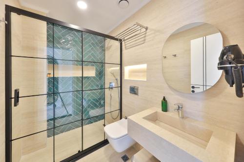 a bathroom with a sink and a shower at Sardunya Otel ARKA BİNA in Kaş
