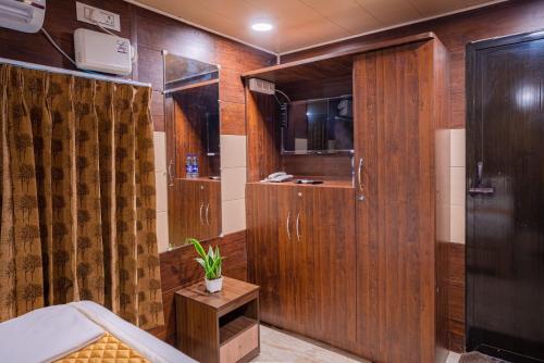 a bathroom with a shower and a toilet in it at Dusk and Dawn Beach Resort in Rāmeswaram