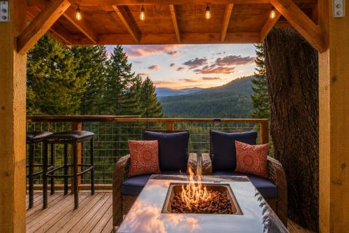 a patio with a fire pit on a deck at Das Tree Haus by NW Comfy Cabins in Leavenworth