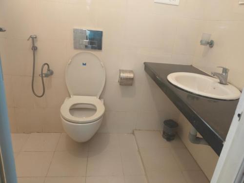 a bathroom with a toilet and a sink at Palm Beach View Resort Cherai in Cherai Beach