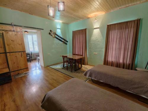 a bedroom with two beds and a table in it at kutaisi base camp in Kutaisi