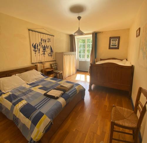 a bedroom with a large bed and a window at Manoir La Buissonnière in Plescop