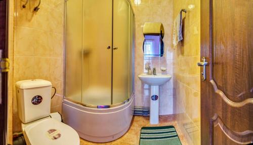a bathroom with a shower and a toilet and a sink at Midas in Kerch