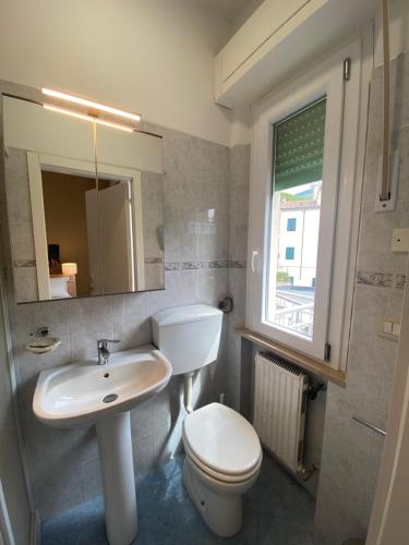 a bathroom with a sink and a toilet and a mirror at Primo Hotel in Marciana Marina