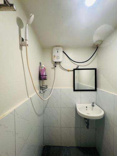 a bathroom with a shower and a sink at Gabs Haven Transient House in El Nido