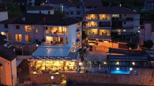 a view of a hotel at night with lights at Boutique Resort Villa VISTA in Malinska