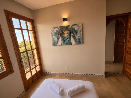 a bedroom with a white bed and a window at Elegant, quiet villa in Marrakesh