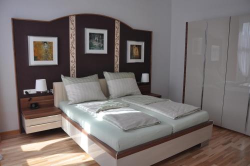 a bedroom with a large bed with a wooden headboard at Business Home Vienna in Vienna