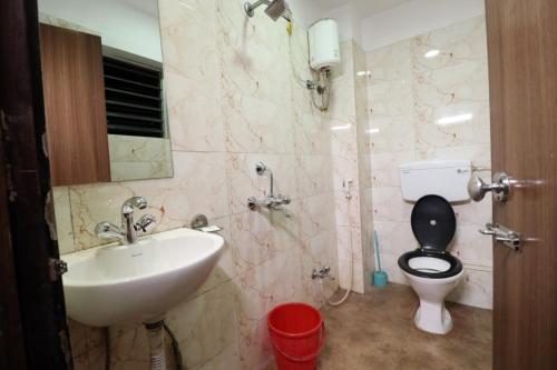 a bathroom with a sink and a toilet and a sink at Hotel best buy in Kolkata