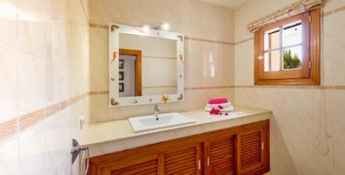 a bathroom with a sink and a mirror at La Vijanera in Sant Jordi