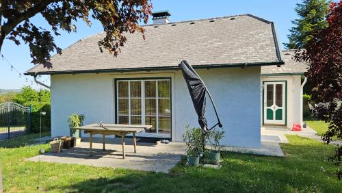 a house with a table and an umbrella in front of it at Gartenidylle Melk in Melk