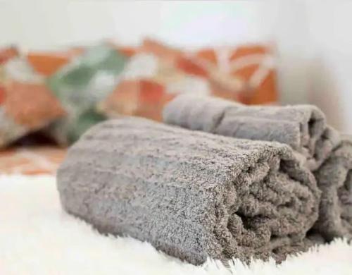 a gray blanket sitting on top of a carpet at "Univeristy" Charming Craftsman - 3 bd, 2ba in Riverside in Riverside