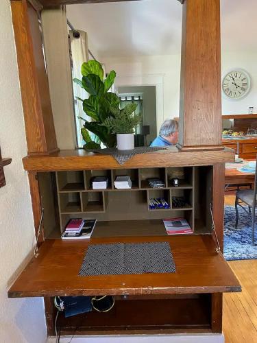 a wooden cabinet with a mirror in a room at "Univeristy" Charming Craftsman - 3 bd, 2ba in Riverside in Riverside