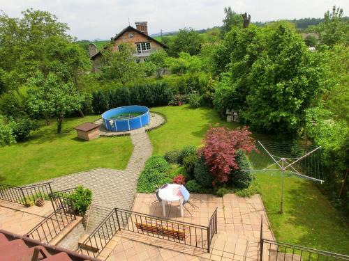 an aerial view of a garden with a pond at Privát Folprechtovi in Dobšín