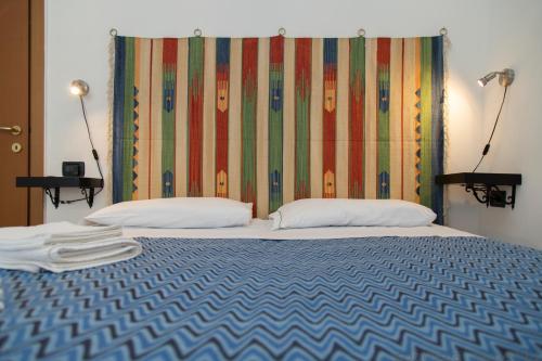 a bedroom with a bed with a colorful headboard at Camere Anna in Vernazza