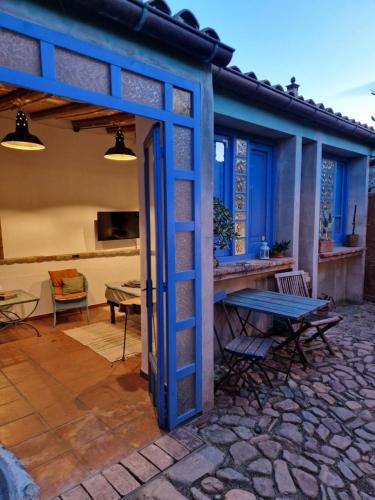 a patio with a blue door and a table at Casa Olive in San Vito