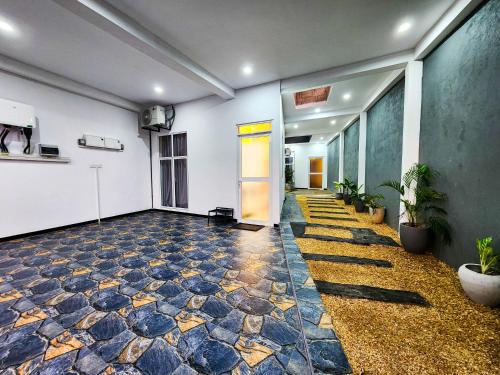 an empty room with a door and a tile floor at Silva Nest Recidencies in Galle