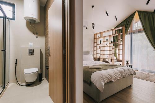a bedroom with a bed and a toilet in a room at Azure Olive Collection in Ulcinj