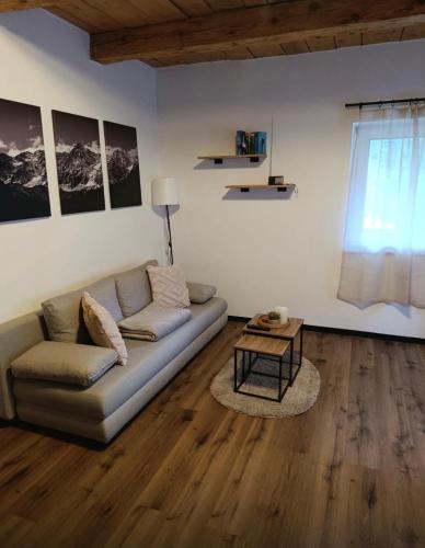 a living room with a couch and a table at Ferienwohnung Storck in Bad Bleiberg