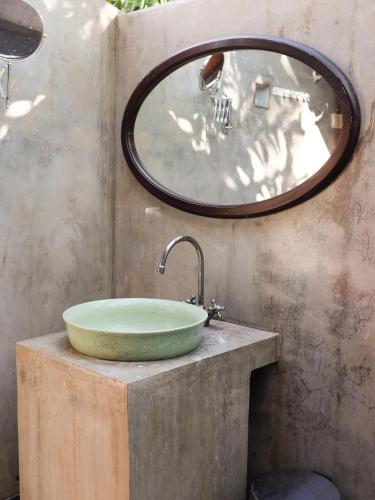 a bathroom with a sink and a mirror at Rumah Jah Langkawi in Pantai Cenang