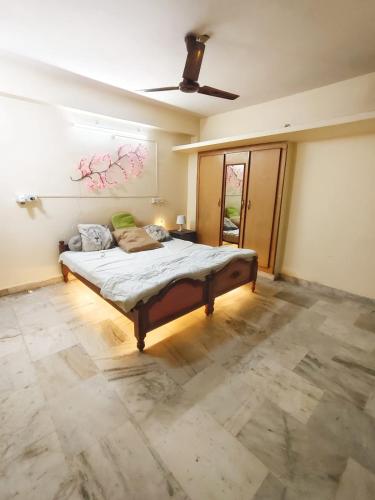 a bedroom with a bed and a painting on the wall at Ravuri's Residency in Hyderabad
