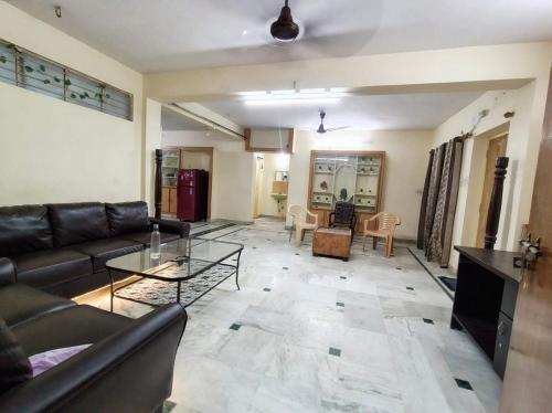 a living room with a couch and a table at Ravuri's Residency in Hyderabad