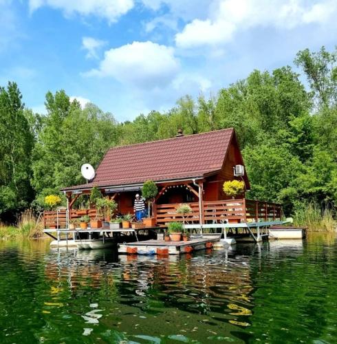 a cabin on a dock on a lake at Hausboat Kvapka in Jarovce