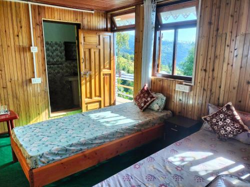 a bedroom with a bed and a window in a room at Dobhanay Homestay in Simāna Basti