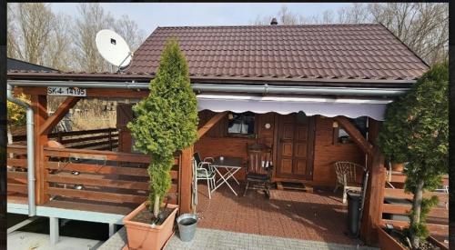 a log cabin with a porch and a patio at Hausboat Kvapka in Jarovce
