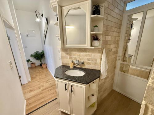 a bathroom with a sink and a mirror at Cozy peak suite in Majdal Shams
