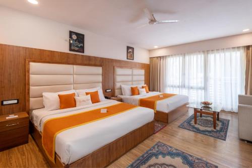a hotel room with two beds and a television at Zone Connect by The Park Katra in Katra