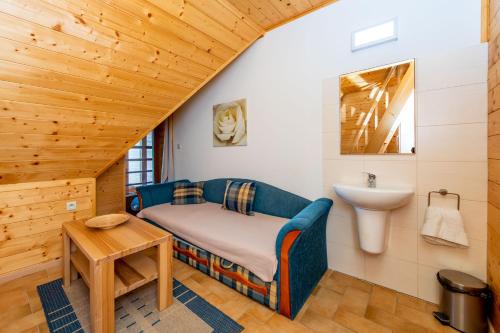 a bathroom with a bed and a sink in a room at Salaš Vígľaš in Bojnice