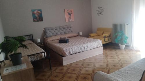 a living room with two beds and a chair at B&B home vintage in Marconia
