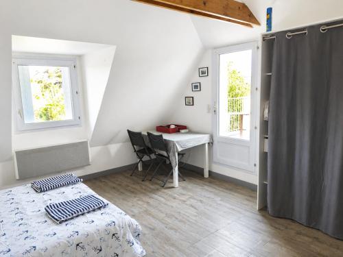 a bedroom with a bed and a desk and a window at Donemat in Arzon