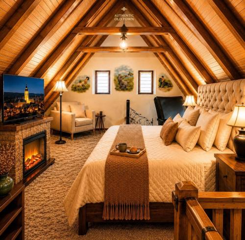 a bedroom with a large bed and a fireplace at Albert Authentic Suites Brasov - Tampa View - Preferred Spa Rates & Exclusive Guest Benefits in Braşov