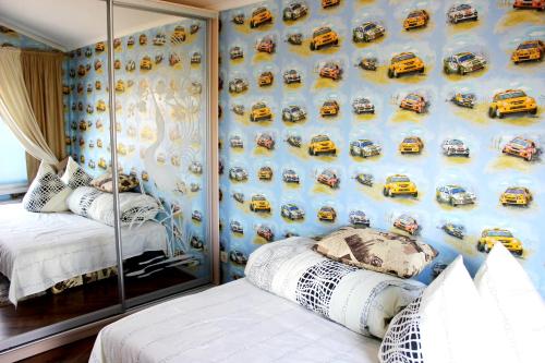 a bedroom with a mural of cars on the wall at Family Complex EkoKomfort in Sagunovka