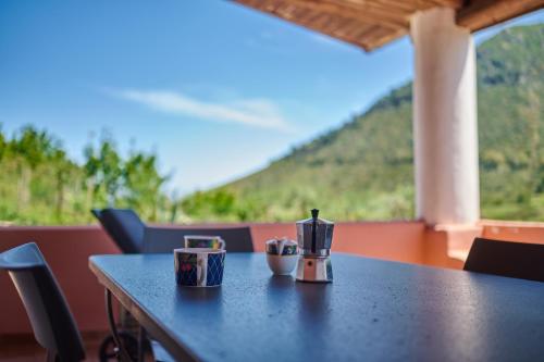 a table with two coffee cups on top of it at Casa Cesare - appartamenti a Salina in Isola Salina