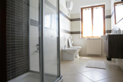 a bathroom with a shower and a toilet and a sink at Casa di Nonna Angela in Guadamello