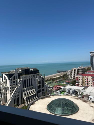 a view of a city with the ocean and buildings at Orbi Residence in Itʼkhvisi