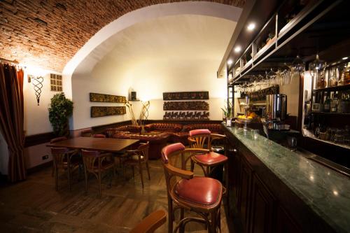 a bar with chairs and tables and a couch at Hotel Gran Duca in Livorno